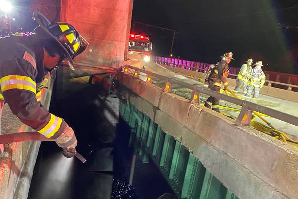 Photos: UPS truck catches fire, dangles from bridge